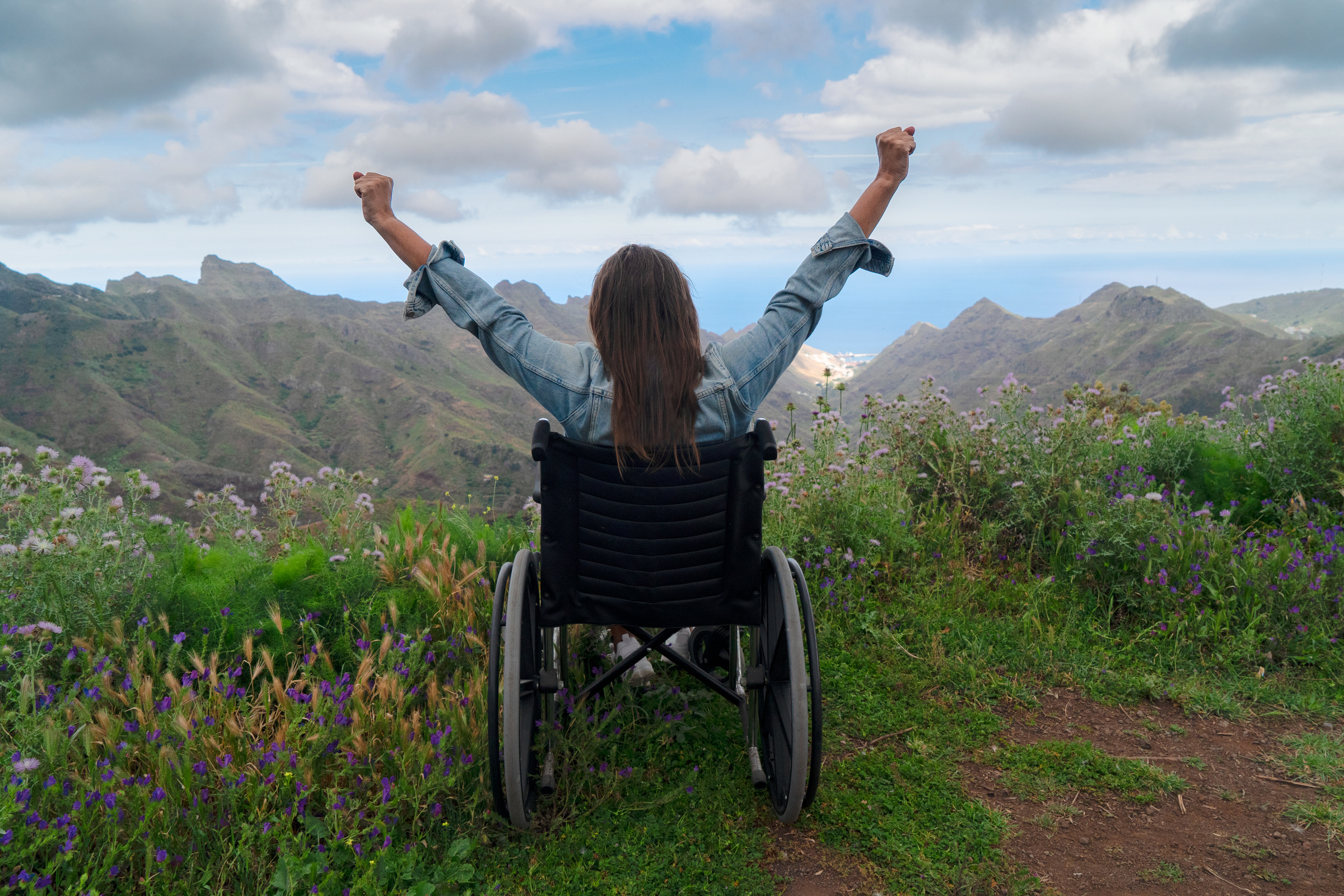 Disabled  Woman in Wheelchair on Mountain Hill Enjoying View
