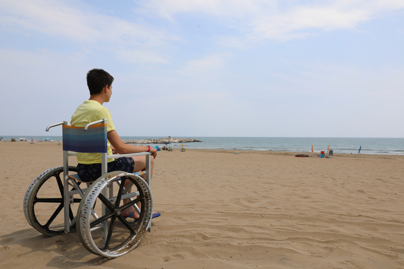 young disabled boy on the beach