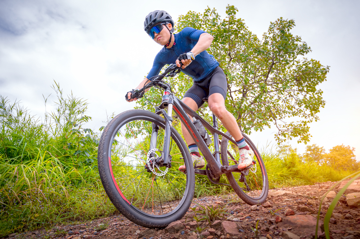 Mountain bikers ride MTB, mountain bike downhill to the extreme.  Asian man rides MTB, mountain bike downhill in the wild to extremes. Extreme Sport and MTB, mountain bike downhill Concept.