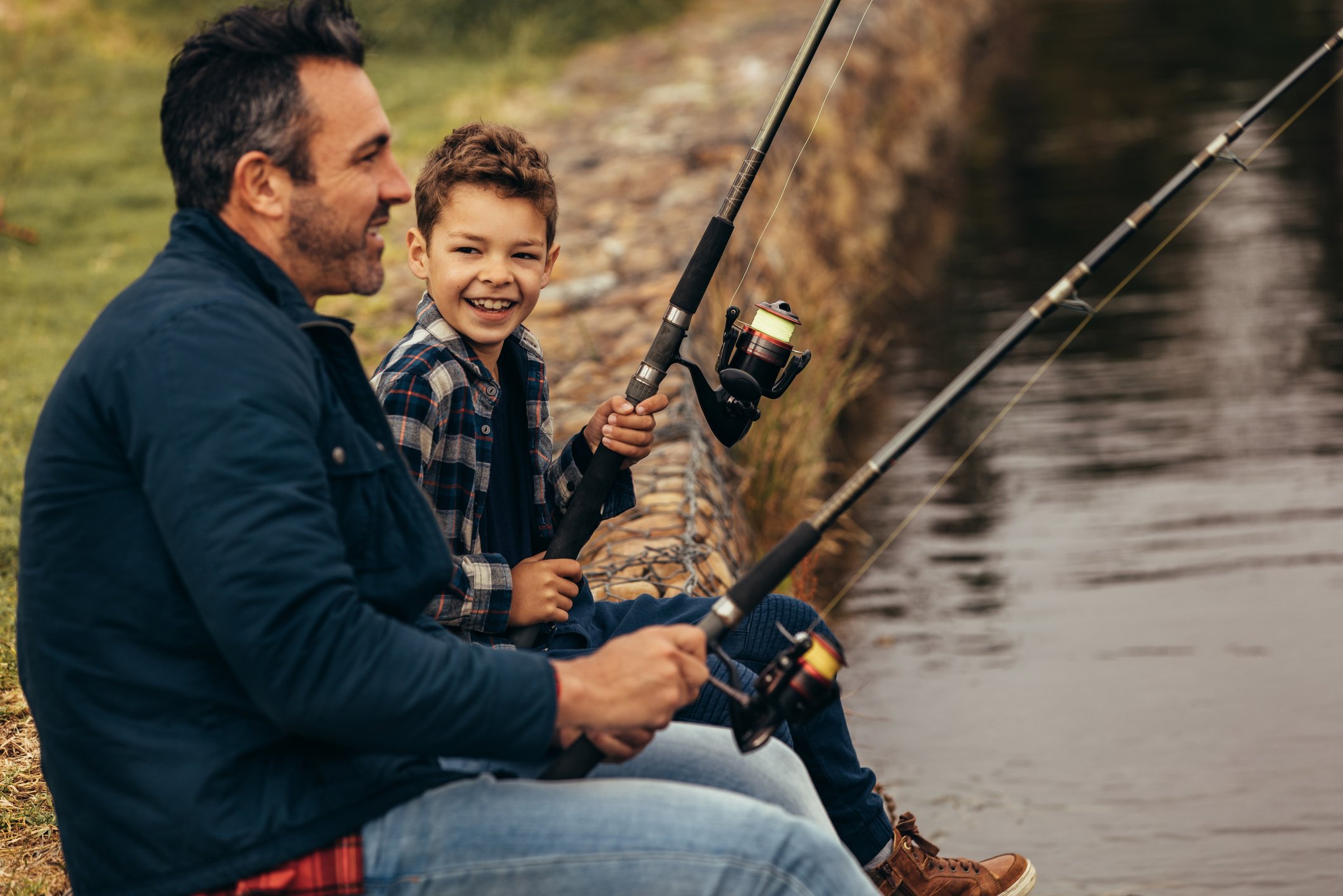 Happy Man and Kid Fishing in a Lake