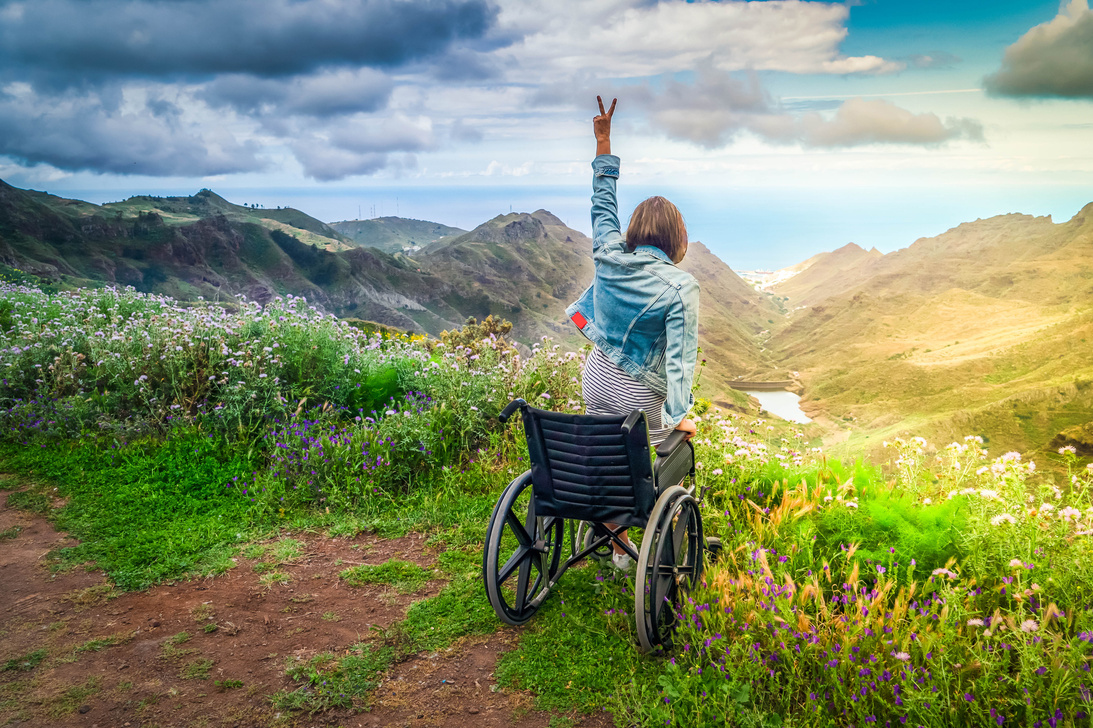 Disabled  Woman in Wheelchair on Mountain Hill Enjoying View